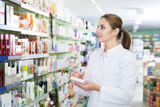Woman druggist is inventorying medicines