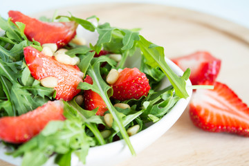 Fruit salad from arugula and strawberries.