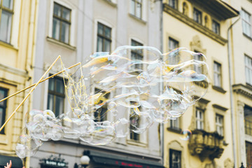 soap bubbles in the center of old european city. having fun