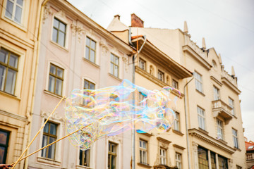 soap bubbles in the center of old european city. having fun