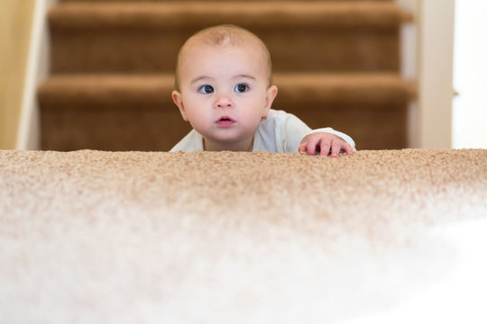 Toddler Girl Climbing Up The Stairs In Her House