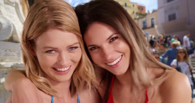 Pretty blonde female with best friend smiling at camera in front of Spanish Steps in Rome, 2 young ladies traveling in Rome, Italy posing happily by the Spanish Steps, 4k