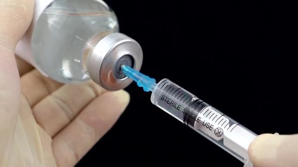 Medication drug needle syringe drug,medical concept flu shot vaccine vial dose hypodermic injection treatment disease care hospital prevention immunization illness disease baby child.black background 