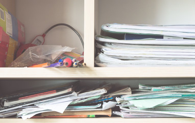 Stacks of notebooks and school supplies - a mess in the closet