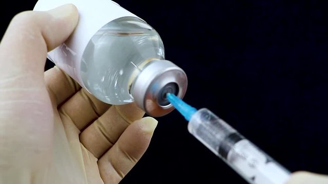 Medication drug needle syringe drug,medical concept flu shot vaccine vial dose hypodermic injection treatment disease care hospital prevention immunization illness disease baby child.black background 