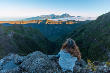 Girl watching the Piton des Neiges from the Riviere des Remparts in Reunion Island