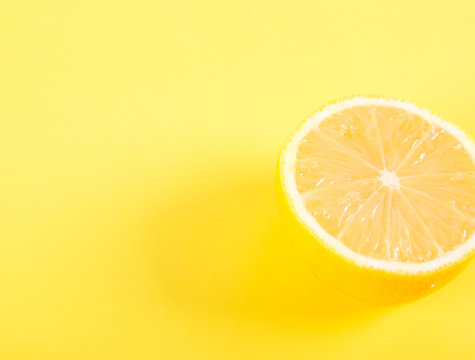 Half of lemon on a yellow background