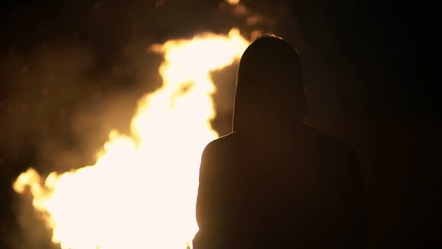 Revolution destructive behavior guy In the background is a fire. shooting at night