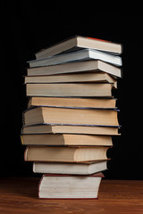 A stack of books on a black background.