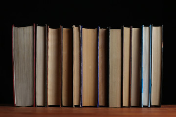 A stack of books on a black background.