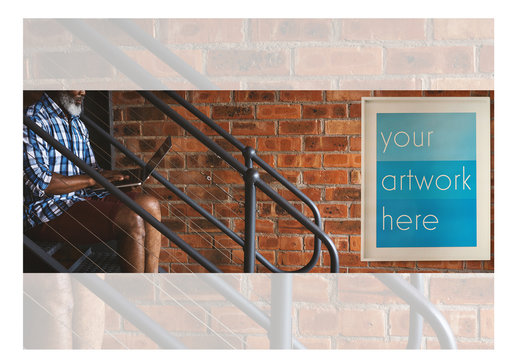 White Framed Poster with Man Using Laptop on Stairs Mockup