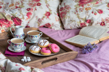 Breakfast in bed with coffee and donuts