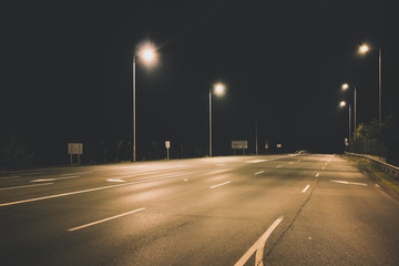 Fototapeta na wymiar night empty highway under lanterns light concept