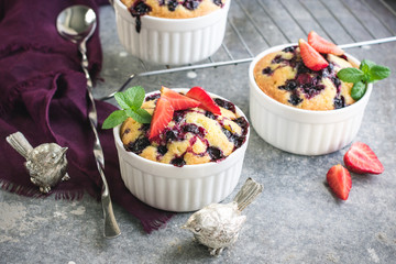 Small berry pies in a ceramic baking dish.