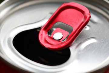 Aluminum can with red pull ring close-up. Selective focus