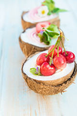 Coconut cupcakes with flowers, strawberries and cheese cream