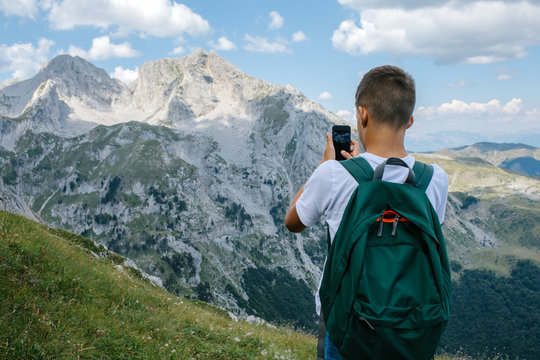 Young man with backpack enjoying beautiful landscaped nature.