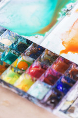 Abstract background concept for school watercolor. Hobbies and education, a cuvette with different watercolors. 