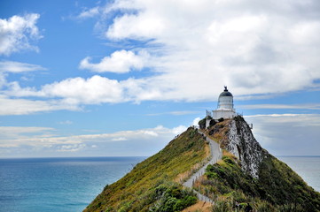 Fototapeta na wymiar Lighthouse on a cliff in the sea