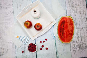 Fresh fruit, a white wooden tray and a ship with blue stripes.