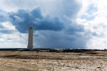 Fototapeta premium Lighthouse in front of stormy clouds in Iceland
