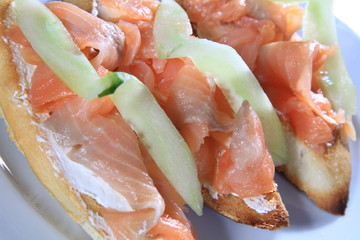 Closuep of salmon sandwiches next to each other