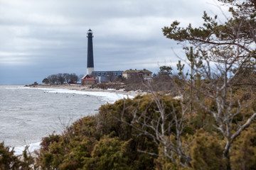 Fototapeta na wymiar Coastline of Baltic sea with Sorve lighthouse on cape at spring season. The Saaremaa island, Estonia, Europe