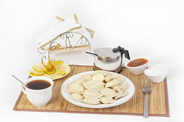 Vareniki with cottage cheese for tea. A perfect addition to the vareniki will be sour cream and a cool sweet jam.