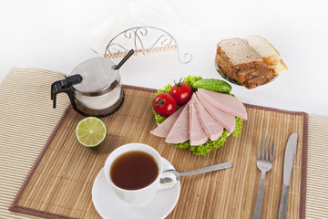 Sausage boiled with greens, tomatoes and cucumbers. Served with black or white bread. This is a good breakfast at the beginning of the day.