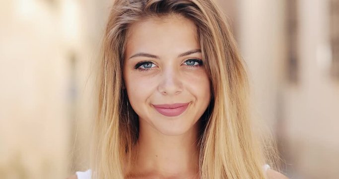 Portrait of beautiful young woman with with blue eyes and attractive smile