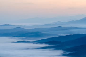 Obraz premium Sunset over mountains and fog. Start the first day of Easter day