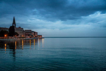 View on a historic center of Porec town and sea at evening after a sunset, Croatia, Europe.