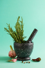 Marble mortar and pestles with rosemary garlic and pepper