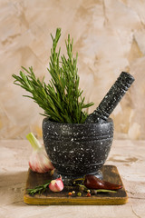 Marble mortar and pestles with rosemary garlic and pepper
