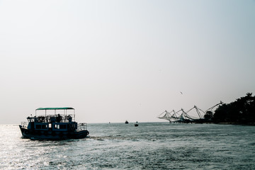 Silhouette of chinese fishing nets in fort kochi during sunset.