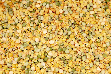 Dried yellow green peas laid out evenly. Photo with a shallow depth of field.