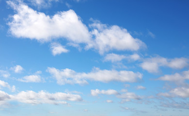 Naklejka na ściany i meble Soft fluffy white clouds in blue sky background