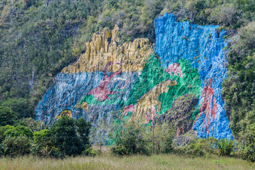 Mural de la Prehistoria (The Mural of Prehistory) painted on a cliff face in the Vinales valley, Cuba. © Matyas Rehak