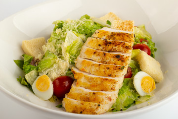 Gourmet caesar salad with grilled chicken croutons.