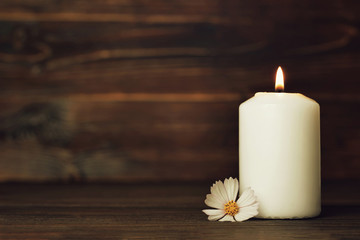 Condolence card with white burning candle and flower