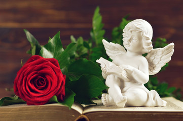 Funeral angel, rose and book. Sympathy card.
