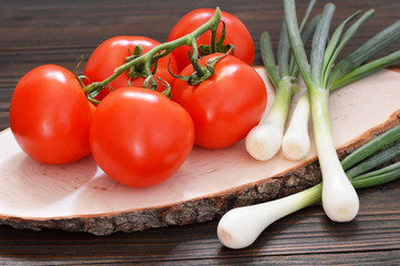 Ripe tomato cluster and green onions