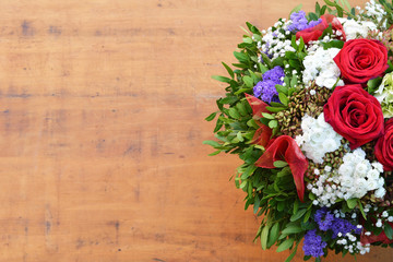 Bouquet of flowers on grunge wooden background