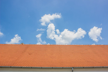 red roof and blue sky horizontal concept  with empty space for copy or text