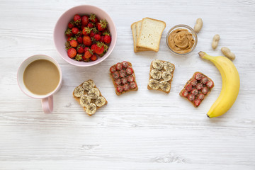 Healthy breakfast with latte. Vegan toasts with fruits, seeds, peanut butter. White wooden background, top view. From above. Flat lay.