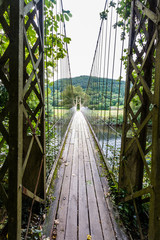 Looking along wooden suspension bridge walkway.