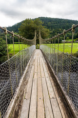 Looking along wooden suspension bridge walkway.