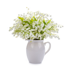lilies of the valley in a porcelain vase isolated on a white background.