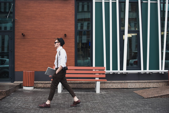 Young stylish guy walking