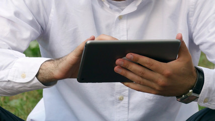 Businessman man hand using tablet device outdoor